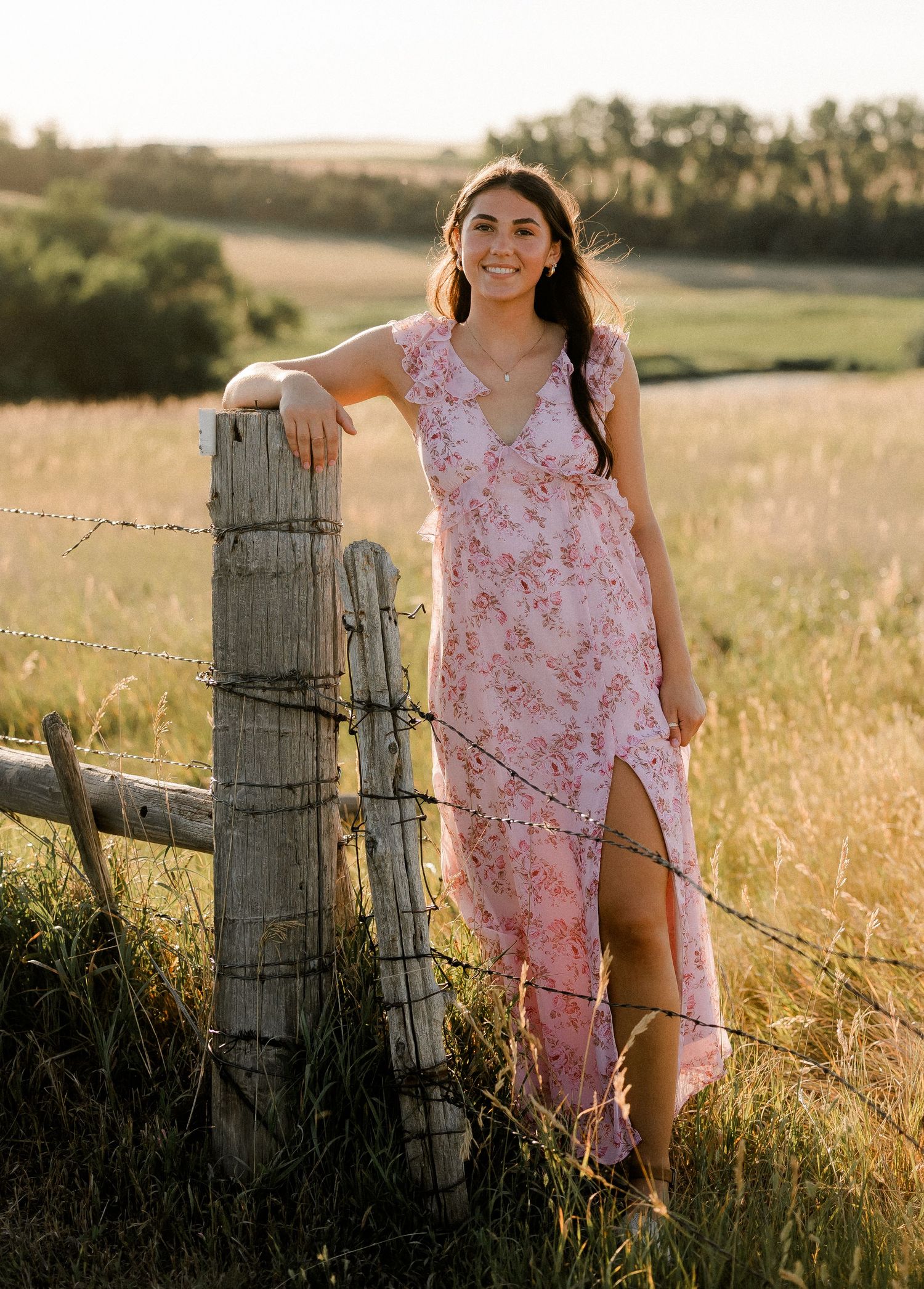 Outdoor senior portrait with soft natural light and relaxed pose