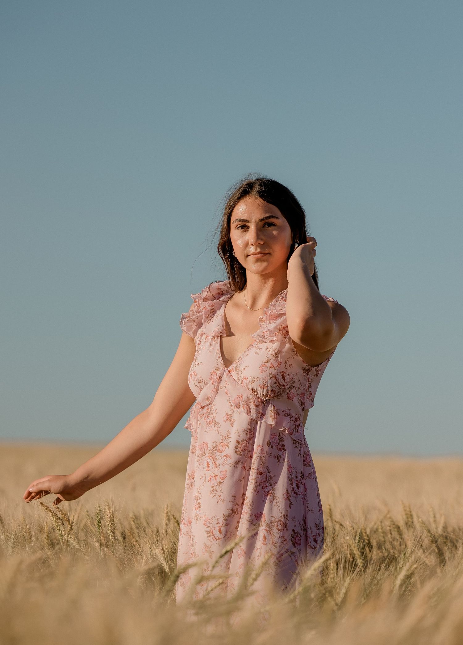 Outdoor senior portrait with soft natural light and relaxed pose