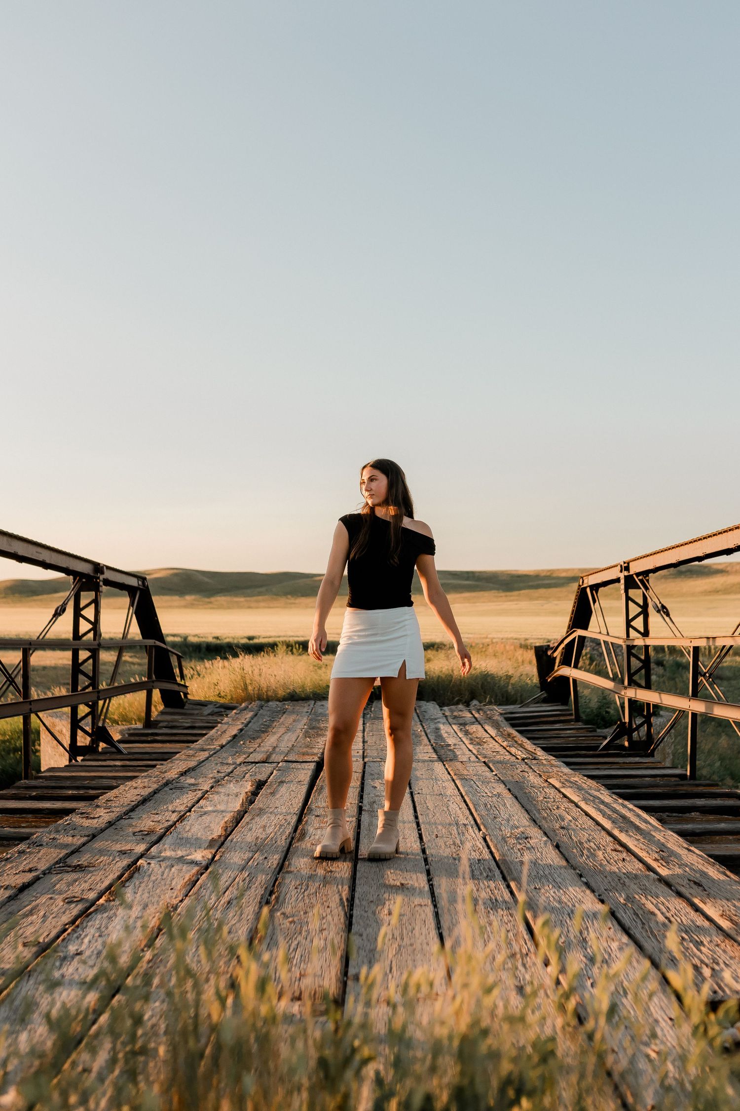Outdoor senior portrait with soft natural light and relaxed pose