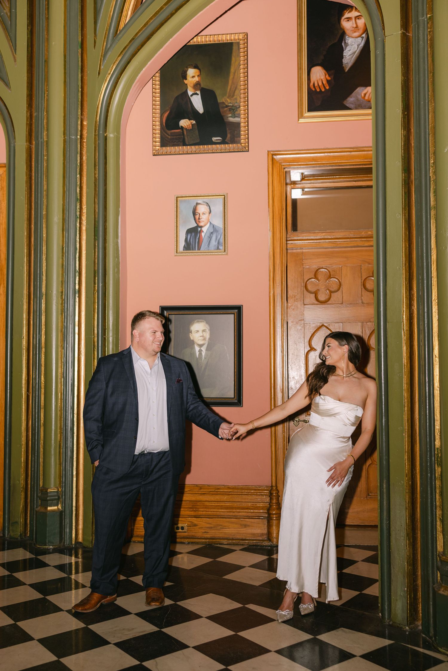 A romantic and editorial direct flash shot of a classy young couple in a historic museum