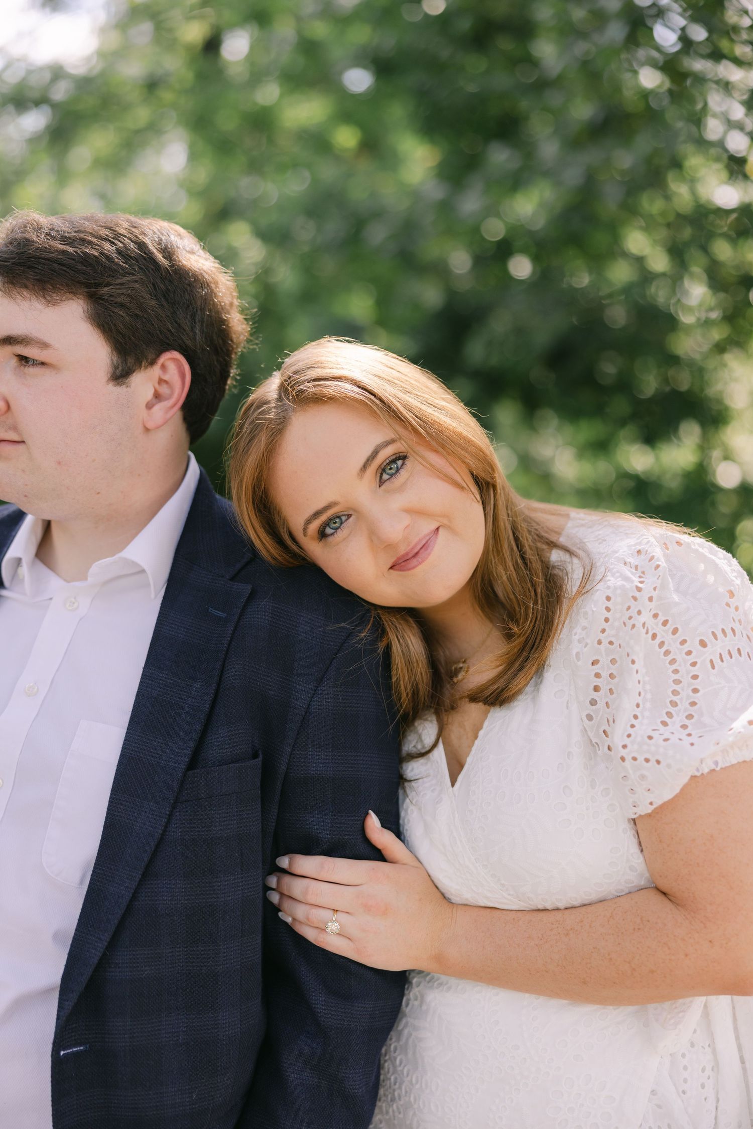A young woman smiles she delicately holds the arm of the man who just proposed to her LOUISIANA WEDDING PHOTOGRAPHER LSU HILLTOP ARBORETUM