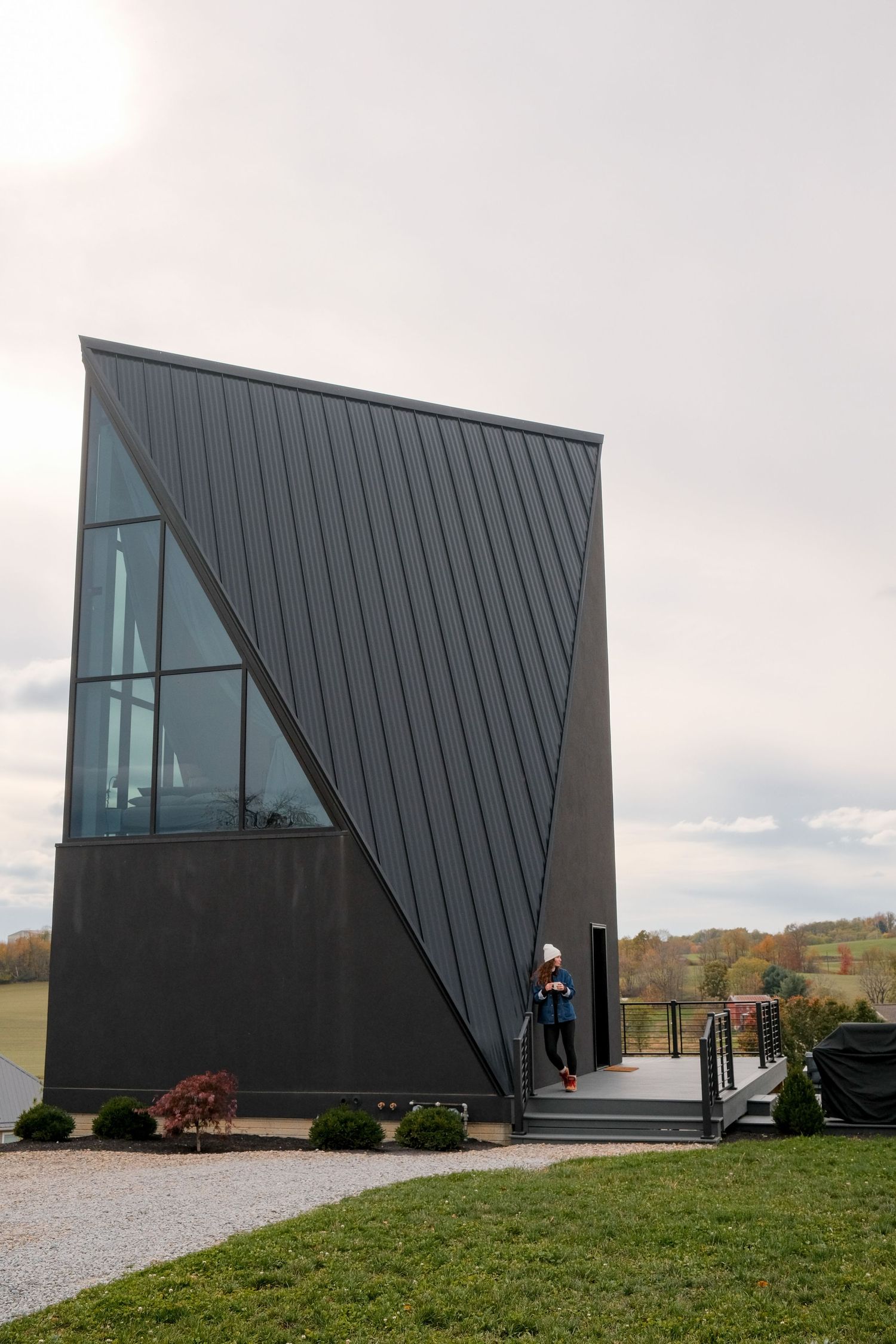 Contemporary A-frame building with dramatic angular black exterior and glass windows.