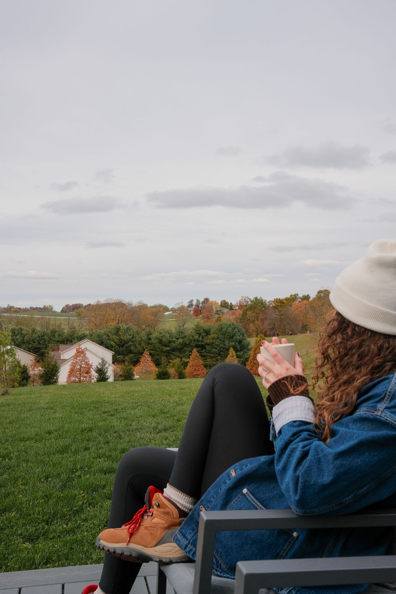 Autumn countryside view with rolling hills and trees showing fall colors in the distance.