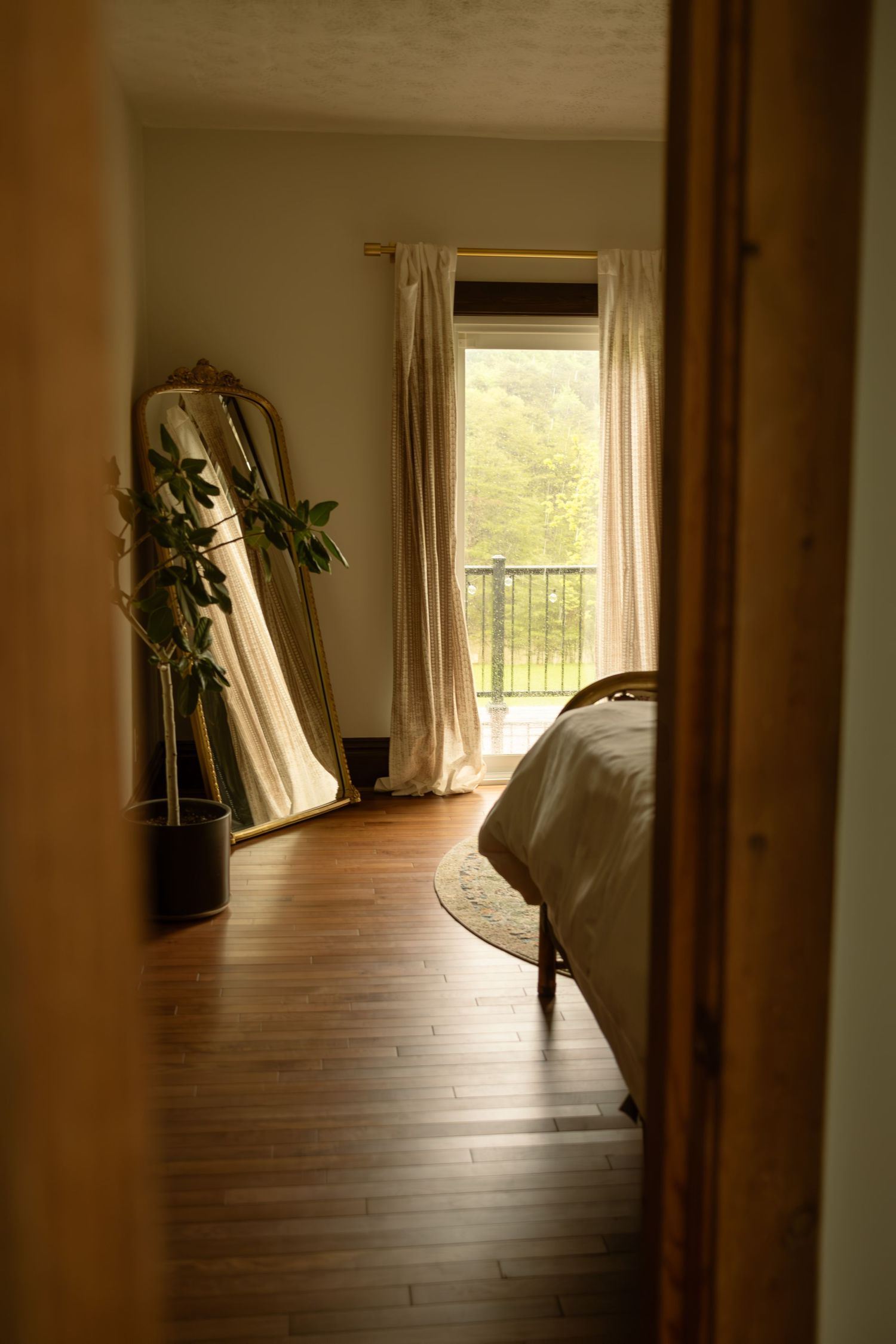 Minimalist hallway with hardwood floors, white walls, and natural light streaming through windows.