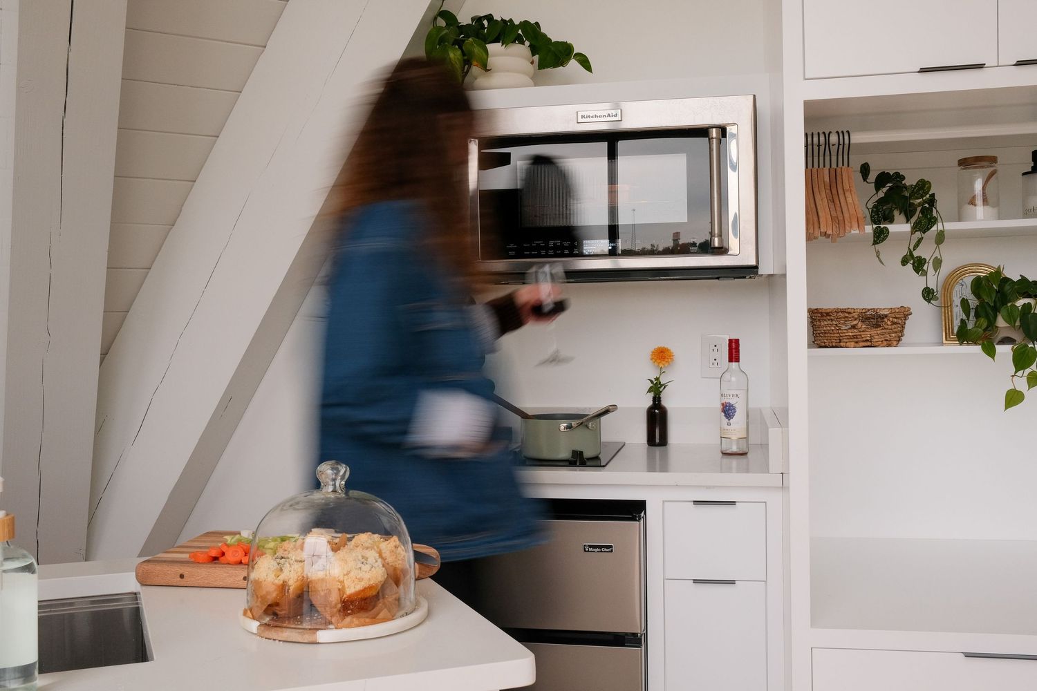 Modern white kitchen interior with sleek cabinets and natural light.