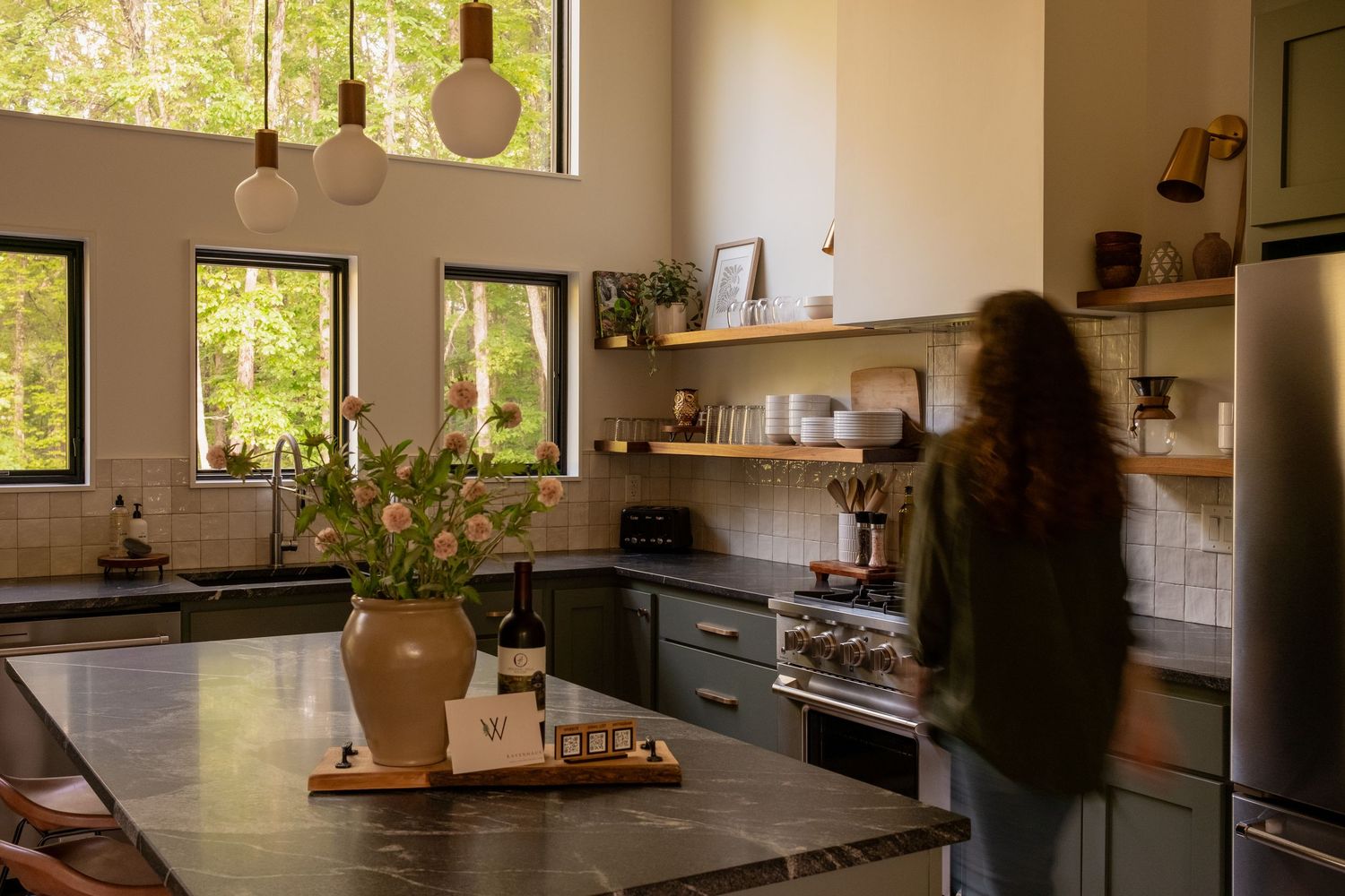 Modern kitchen interior with natural light streaming through windows and wooden accents.