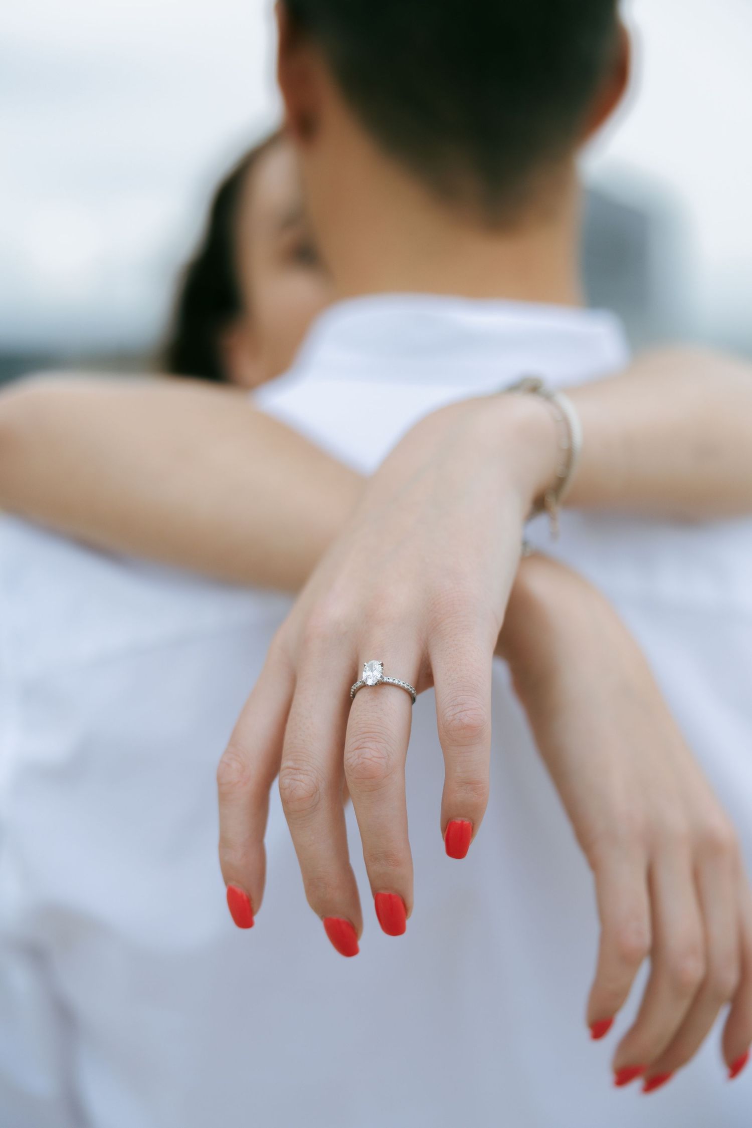 girls hand around fiance neck