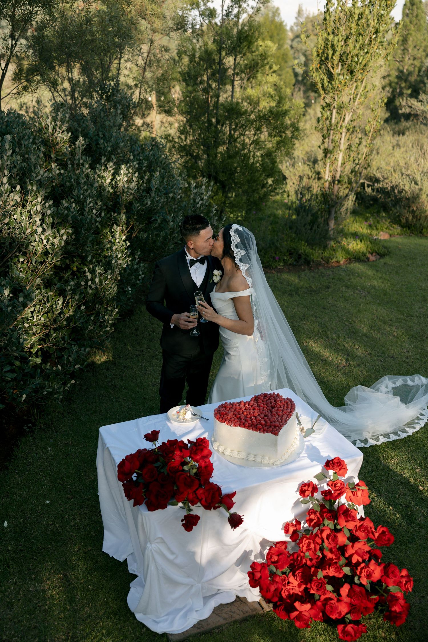 bride and groom kissing after cutting cake