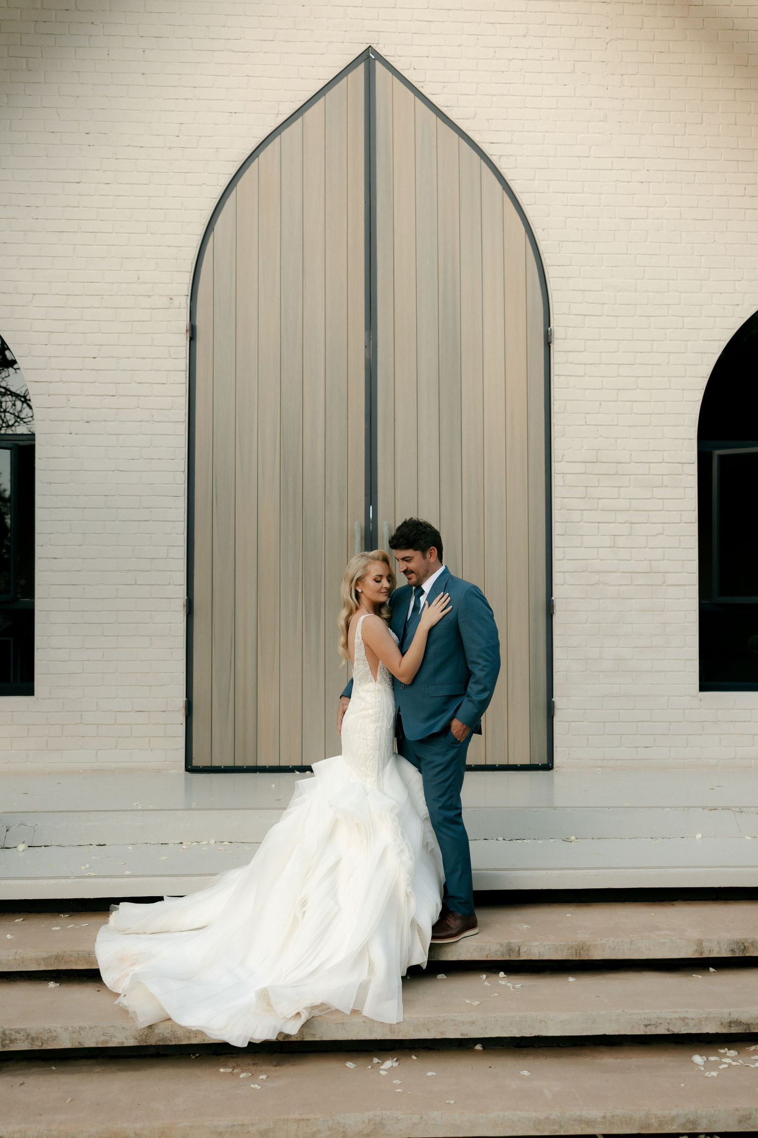 bride and groom posed infront of a chapel door