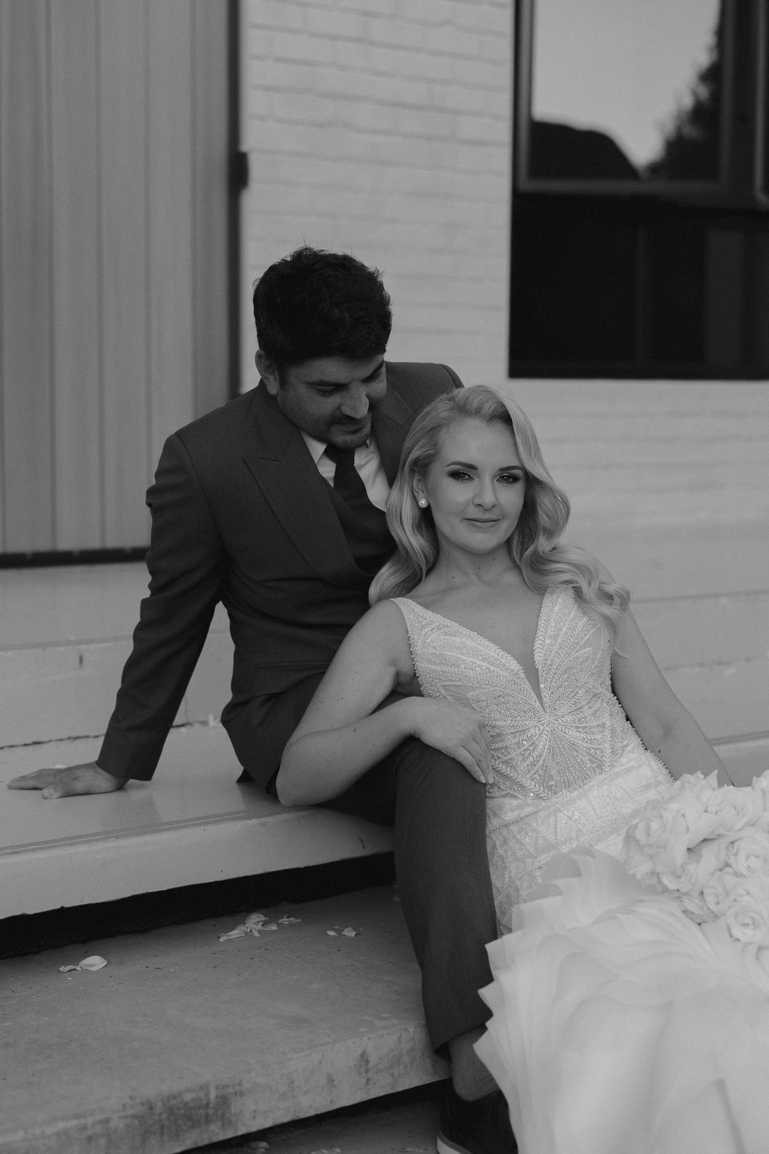 bride and groom posed in stairs