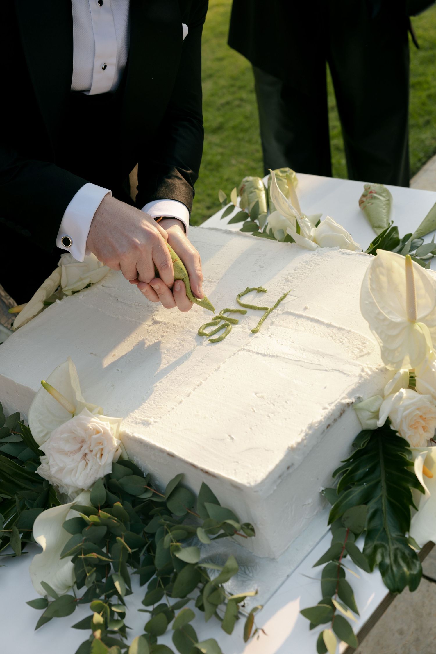 groom cutting cake