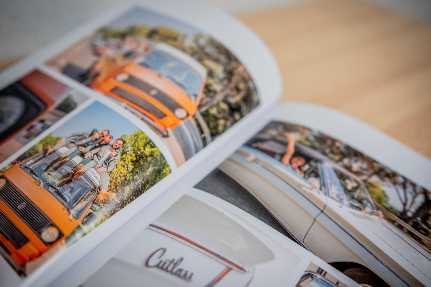 Multiple coffee table photo books are displayed with open pages showing colorful travel and landscape photographs.