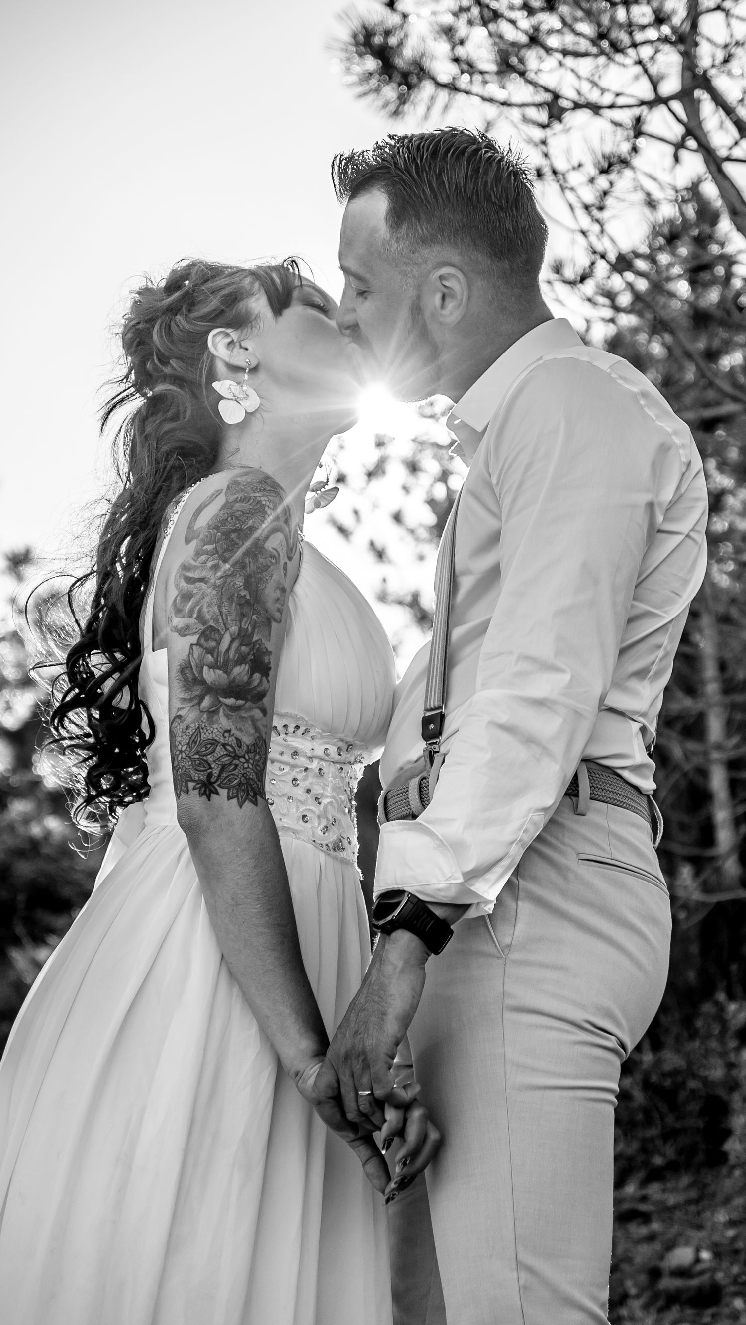 Black and white sequence of romantic wedding couple embracing in a sunlit outdoor setting.
