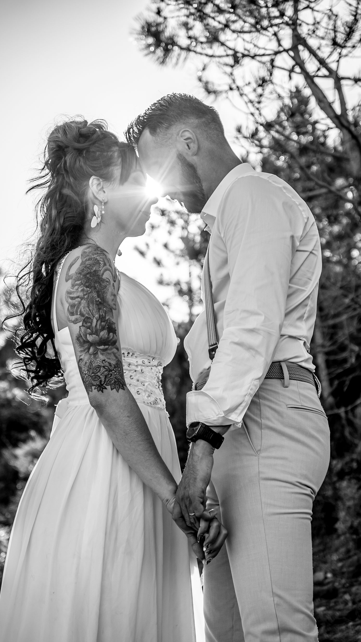 Romantic black and white wedding photo sequence with sunlight filtering through trees.