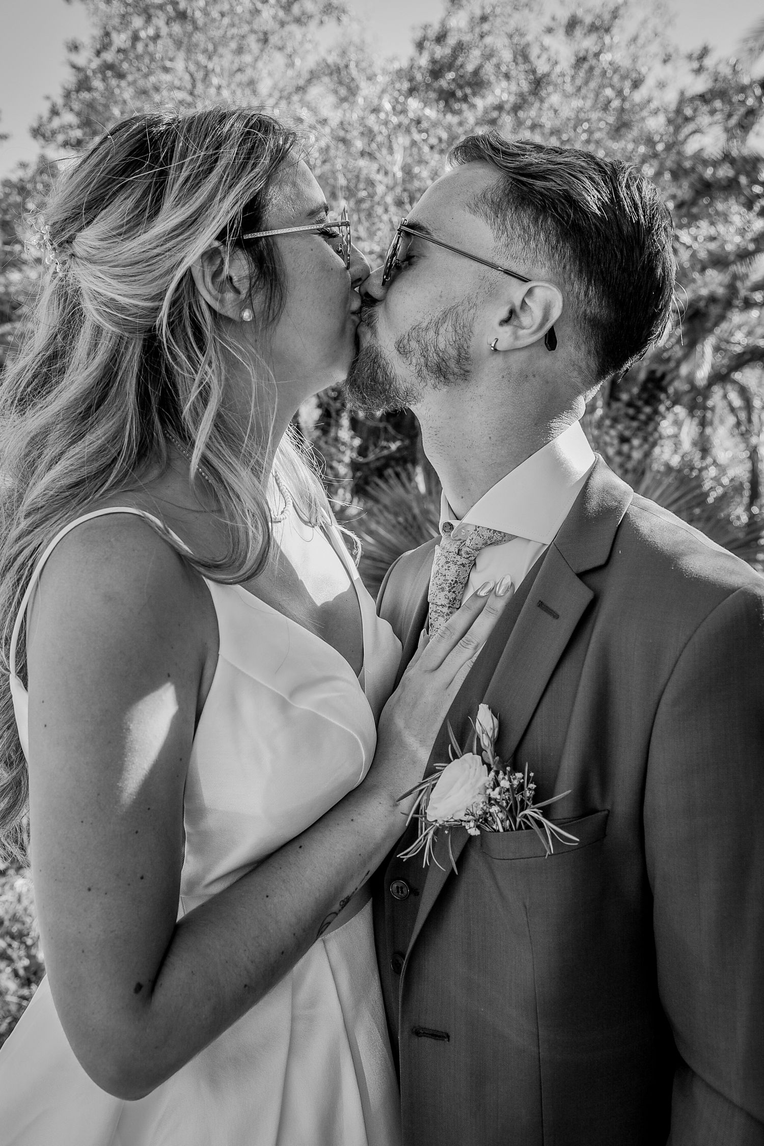 Romantic black and white moment captured in an outdoor garden setting.