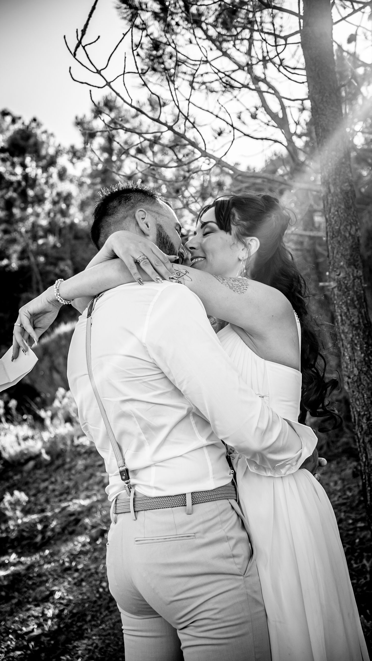 Series of black and white photos showing tender moments between newlyweds in a garden setting.