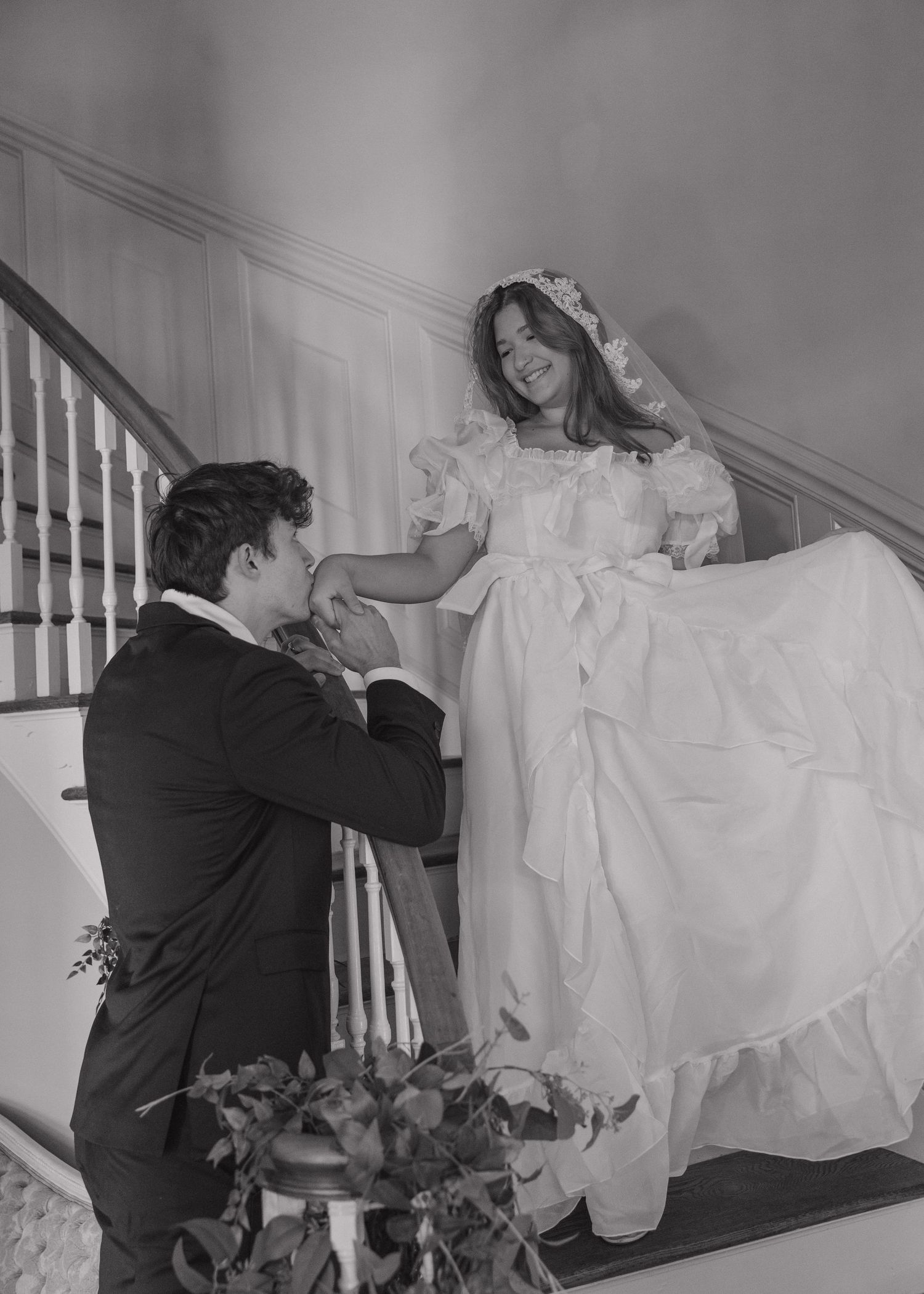 A series of black and white photos showing someone falling down stairs while wearing a wedding dress.