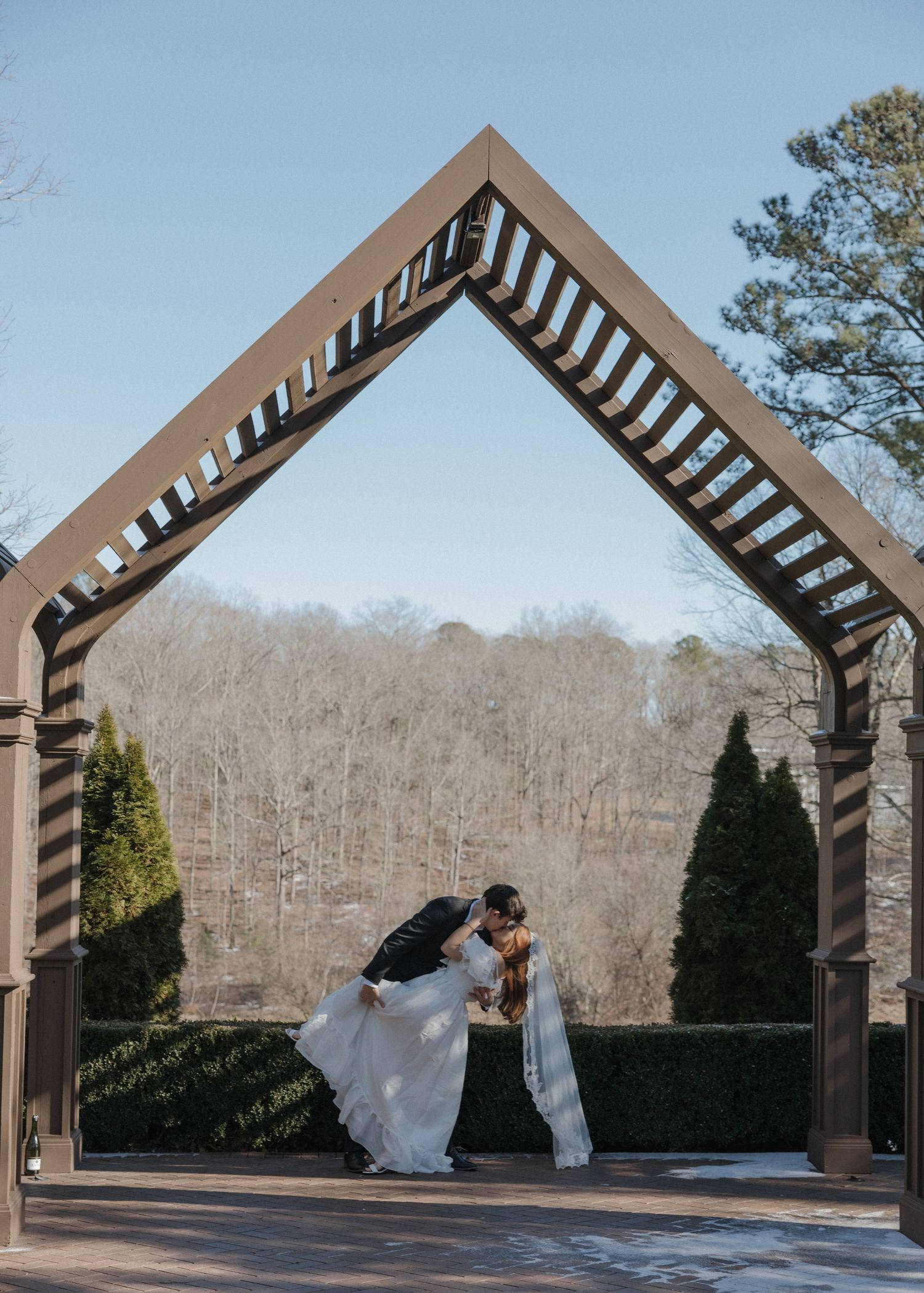 A sequence of photos showing a couple dancing and spinning under a wooden pergola structure in a scenic outdoor setting.