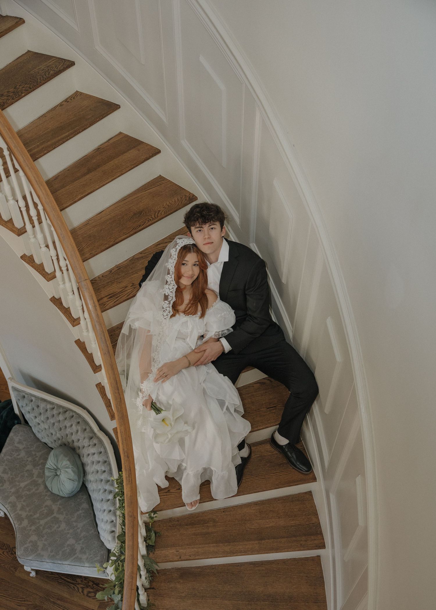 A couple in wedding attire shares romantic moments on wooden stairs in a series of candid photos.
