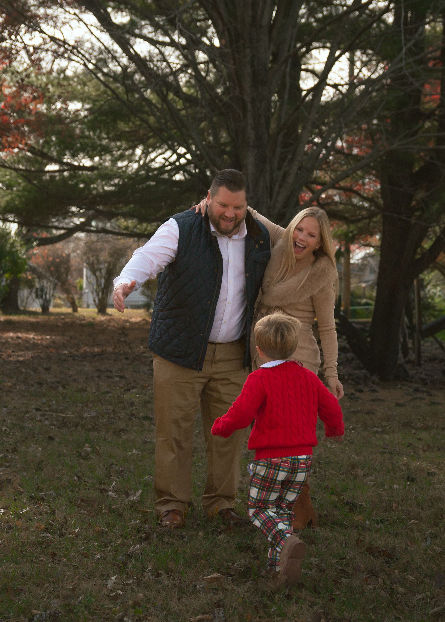 A couple shares playful moments together in a wooded outdoor setting during autumn. Family Photos Montgomery County PA Philadelphia