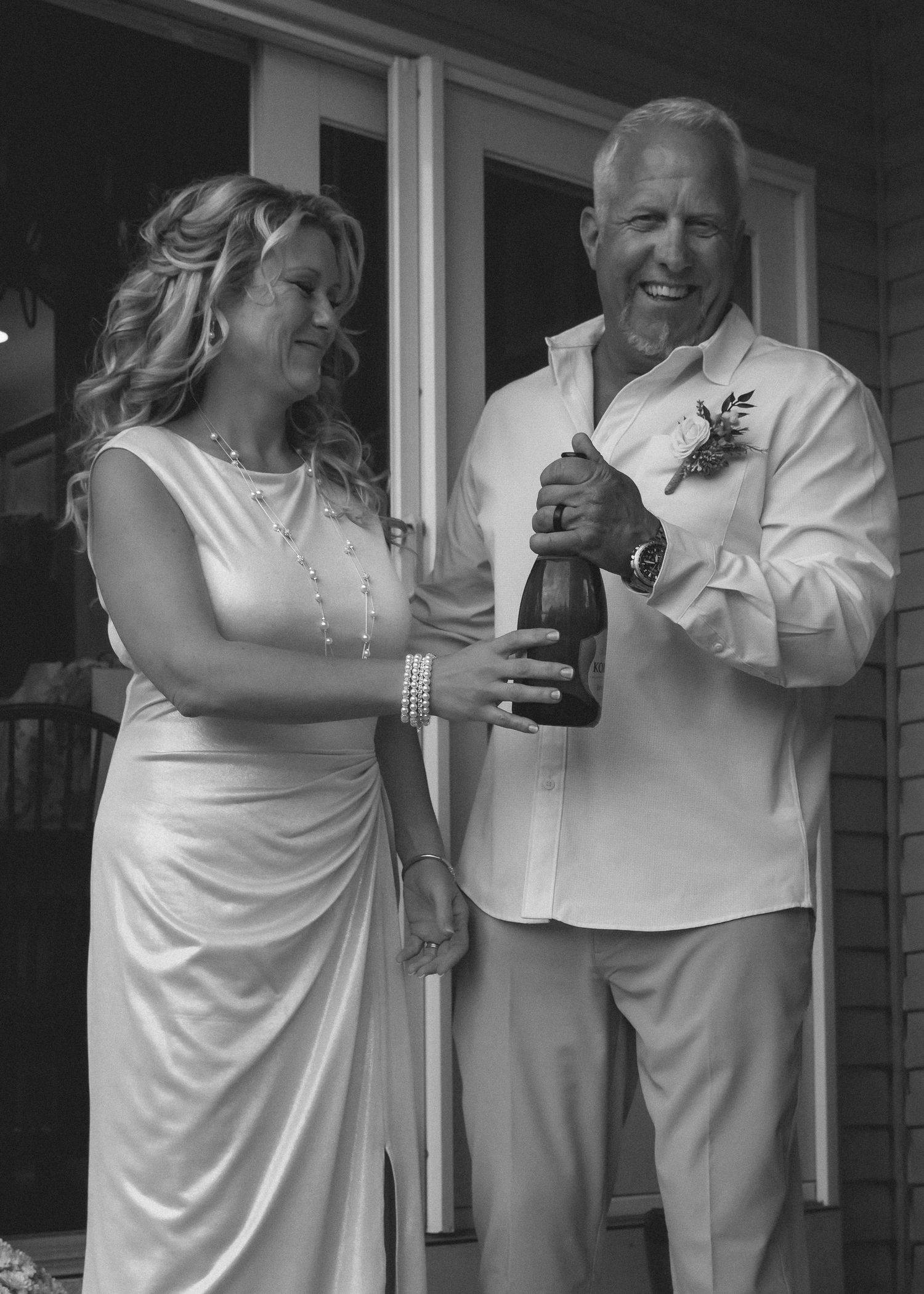 A series of black and white photographs showing two people in white clothing embracing and dancing together.