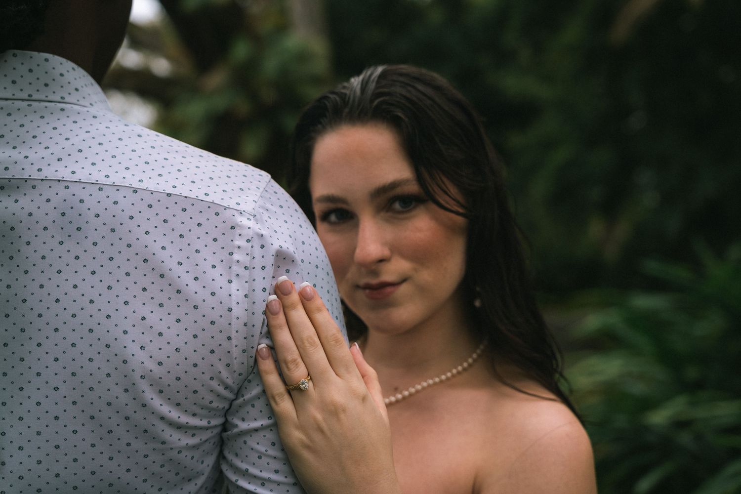 A romantic wedding photo series showing intimate moments between a couple in a lush garden setting.