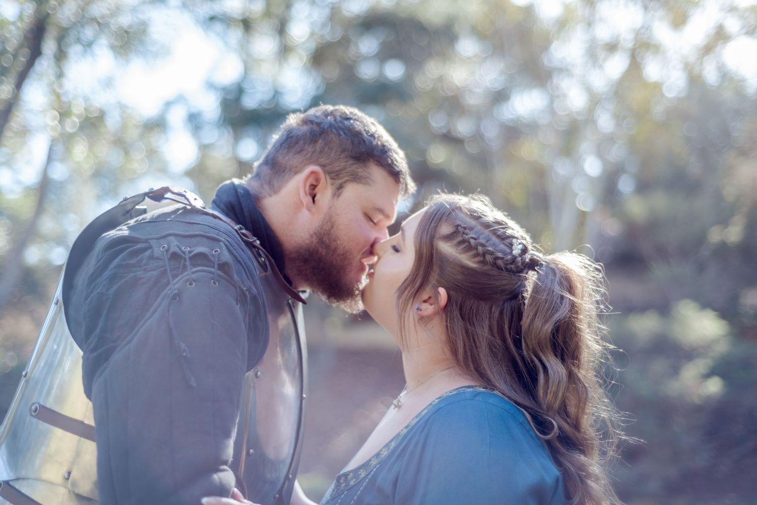 Intimate wedding couple portraits with soft blue tones in a natural outdoor setting.