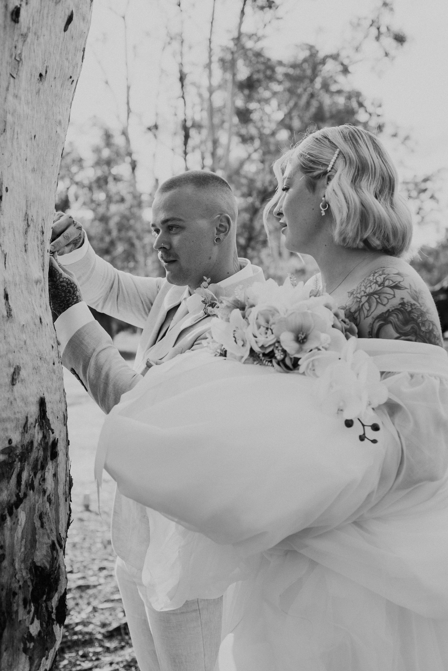 Black and white photos of couple dancing and celebrating outdoors among trees.