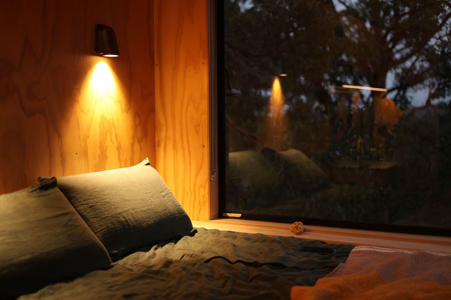 Atmospheric evening lighting creates a cozy ambiance in a minimalist room interior.