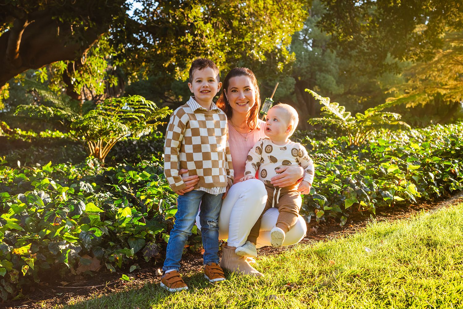 Family gathering at sunset in a lush garden setting.