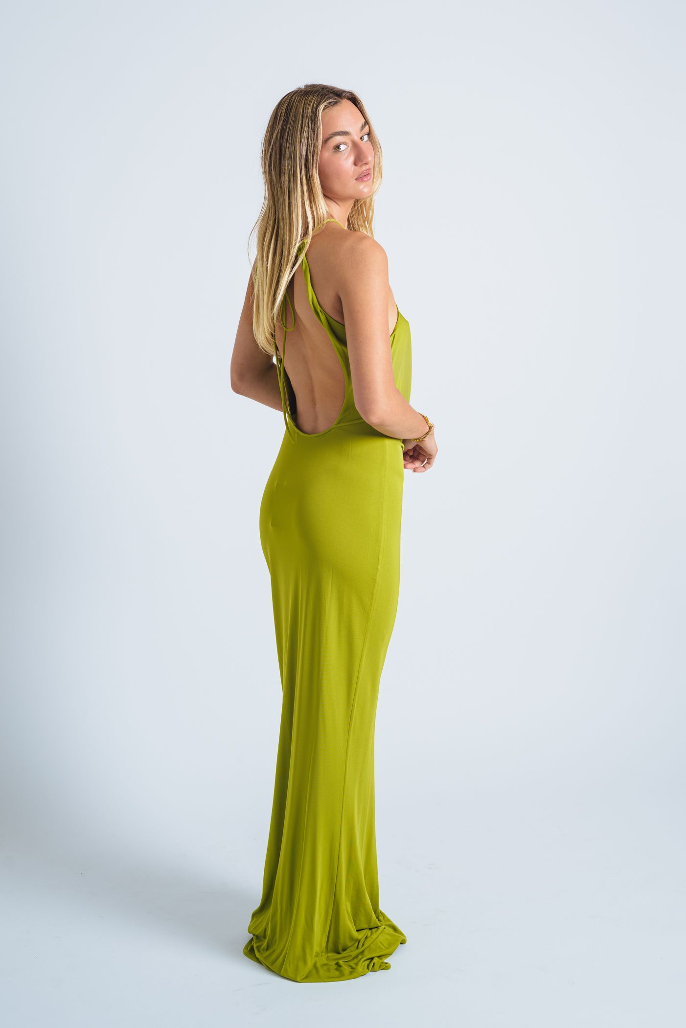 Long lime green dress displayed in studio photo sequence.