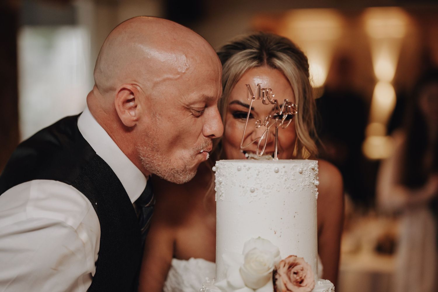 Intimate candlelit wedding reception moment with soft warm lighting.
