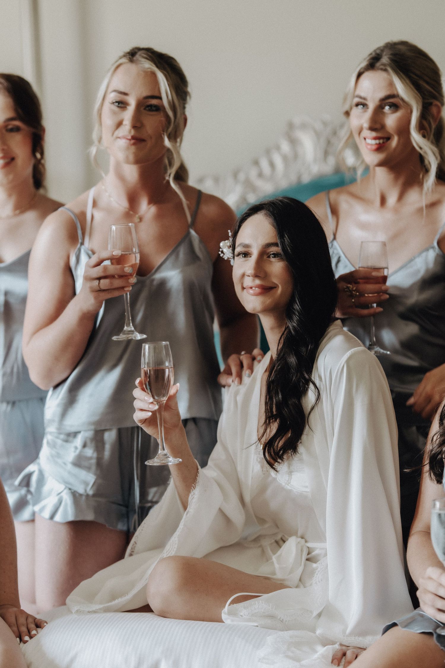 Wedding party enjoying champagne together during pre-ceremony celebrations.