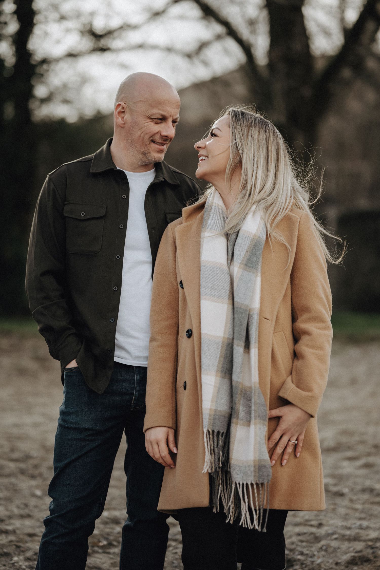 Couple in casual winter wear sharing a loving moment outdoors.
