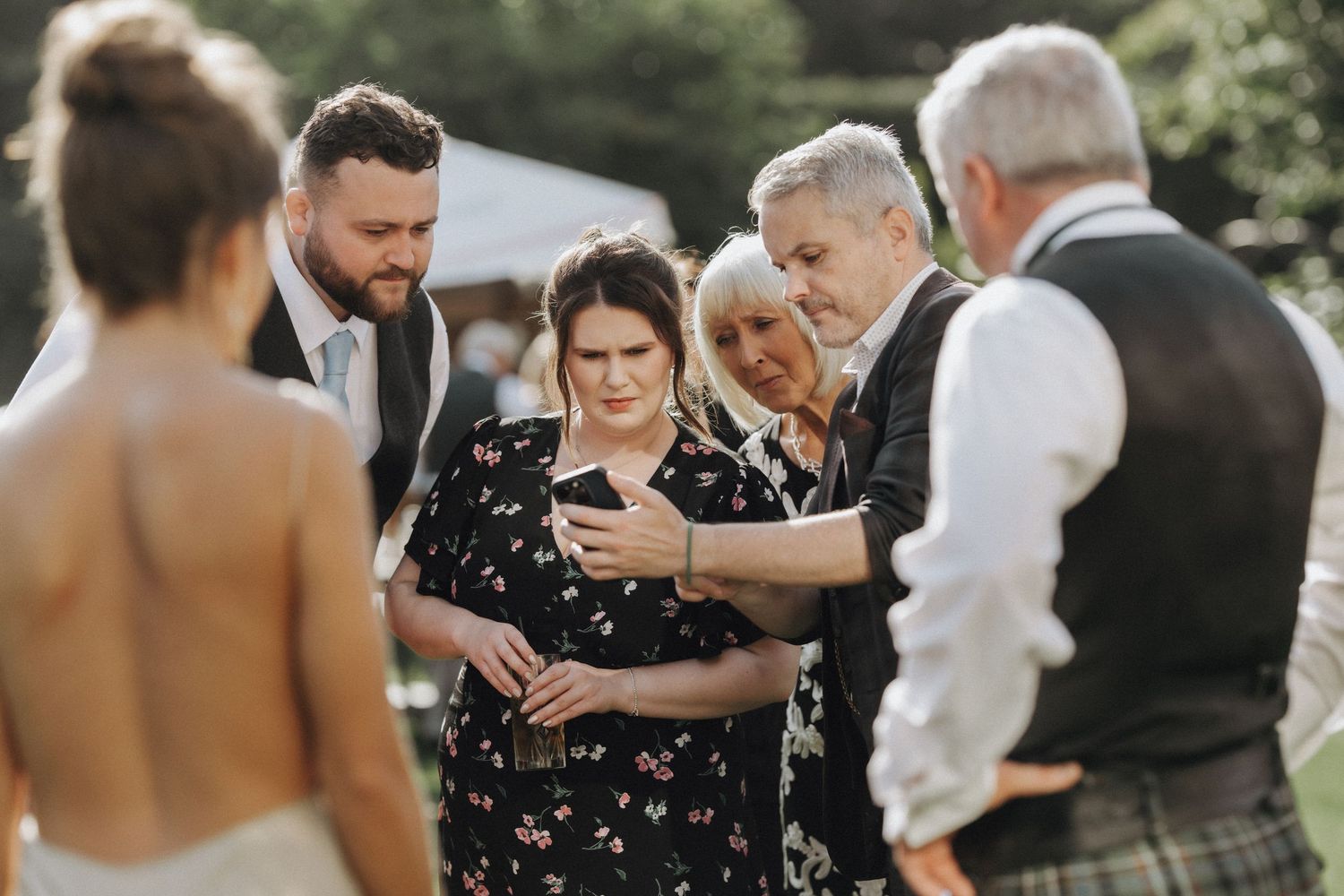 Wedding guests mingling during an outdoor reception.