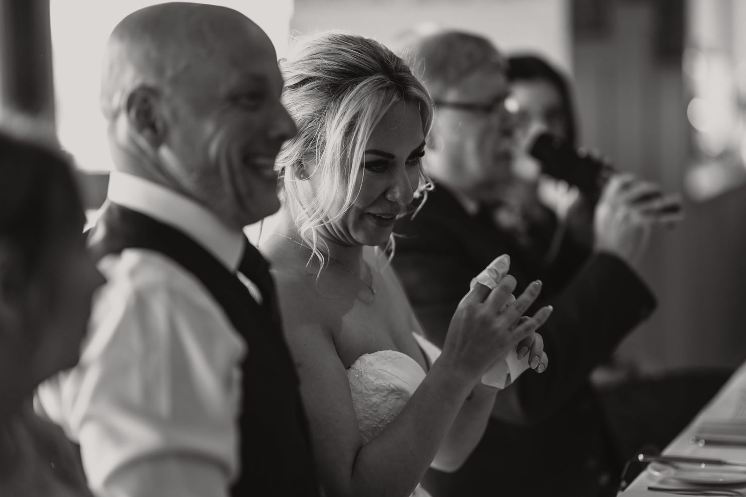 Black and white candid shot of wedding reception celebration.
