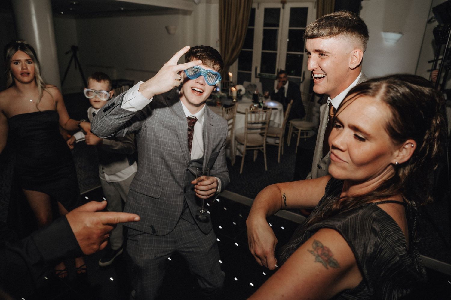 Wedding guests having fun and dancing at reception party.