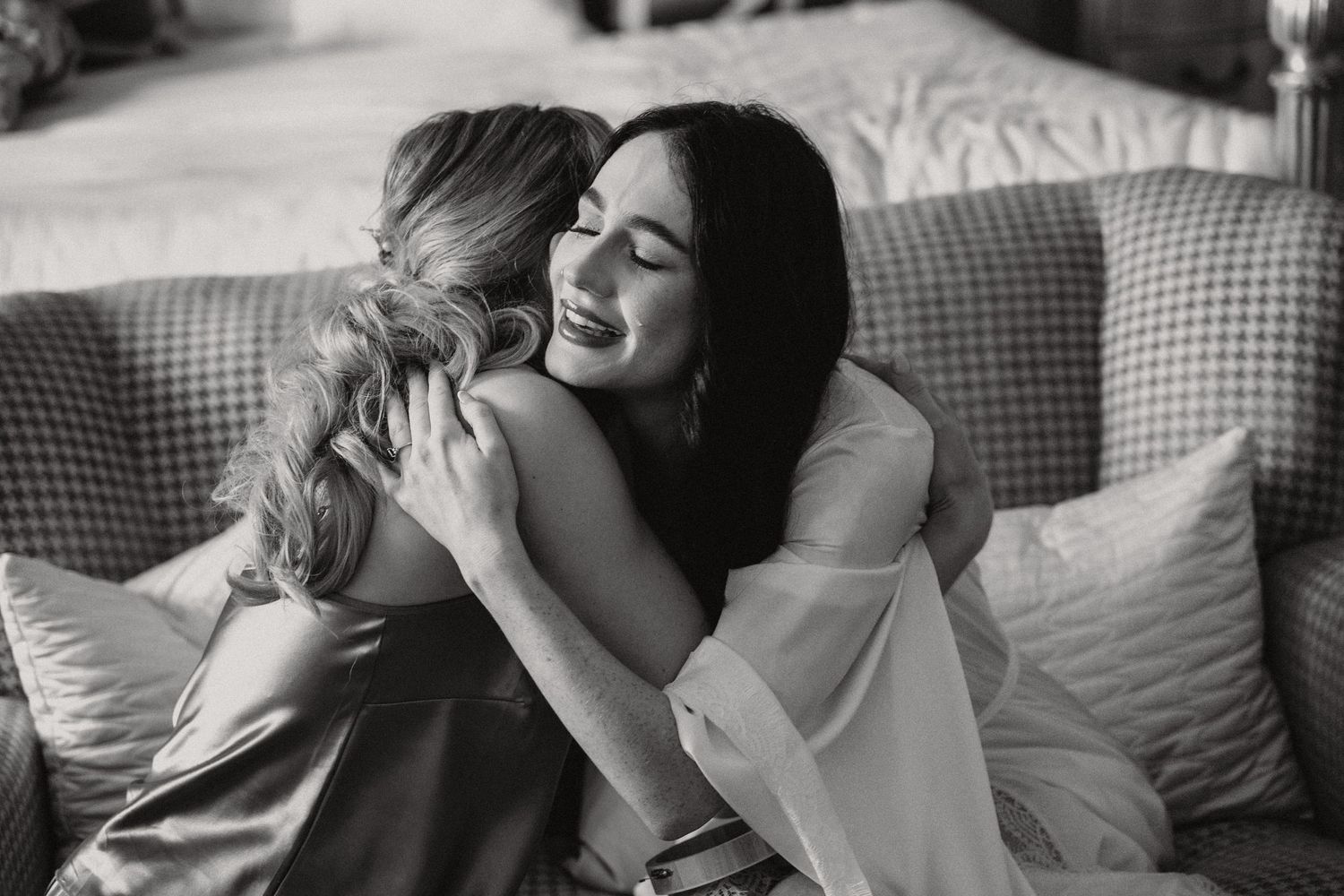 A warm embrace captured in black and white on a comfortable couch.
