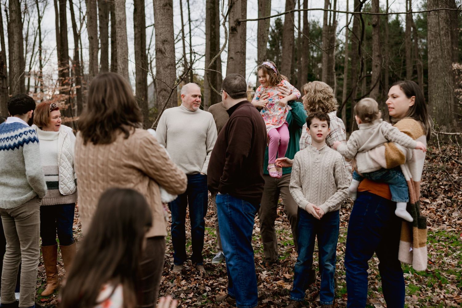 Extended family gathering outdoors in a wooded area during a casual fall photo session.
montgomery county maryland photographer