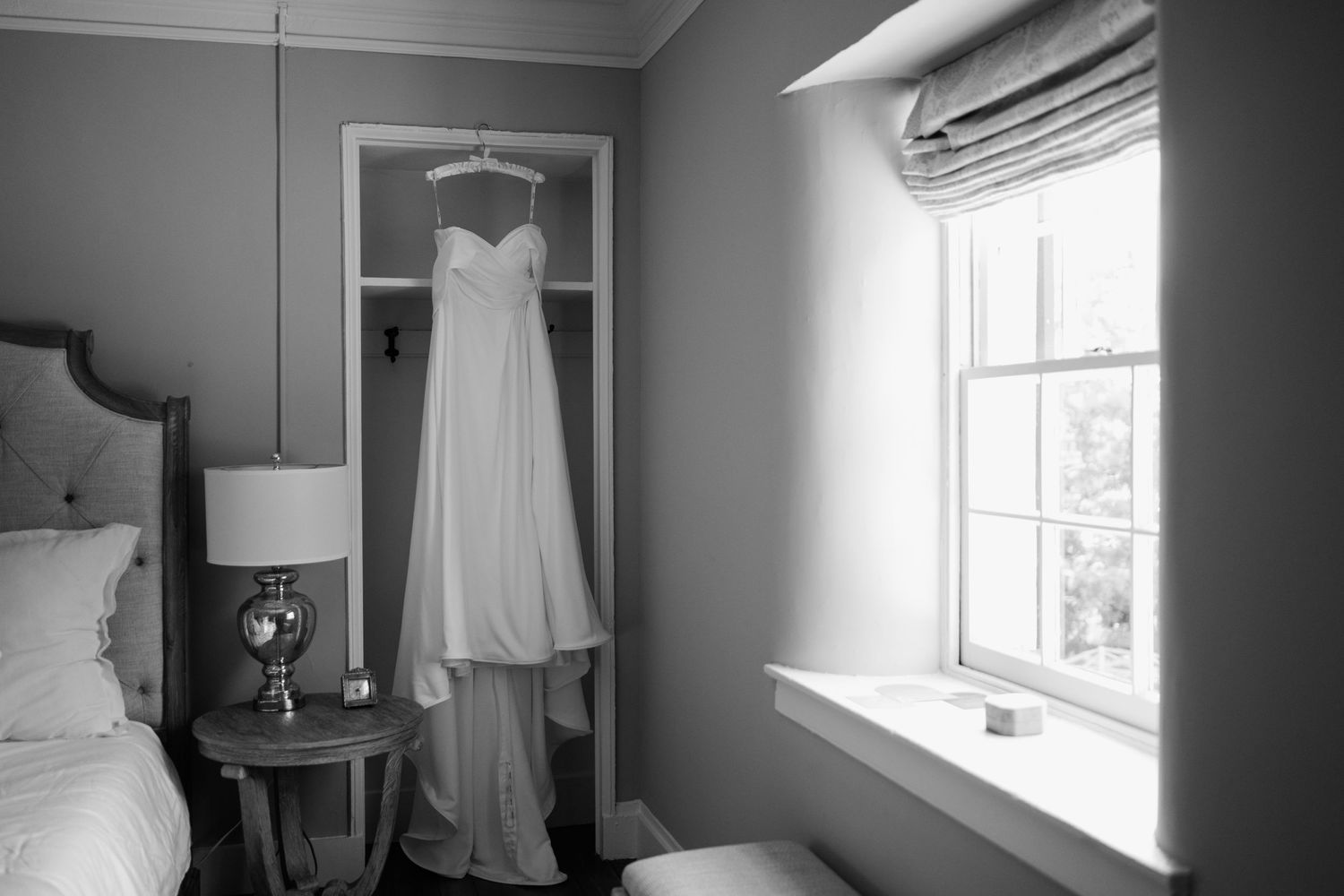 wedding dress hanging in room