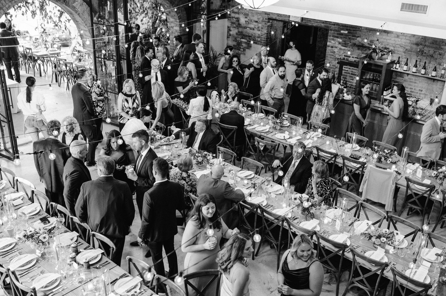guests mingle at reception at woodberry kitchen by maryland wedding photographer
