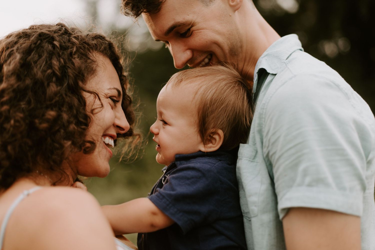 Candid family moment showing pure joy and laughter outdoors.