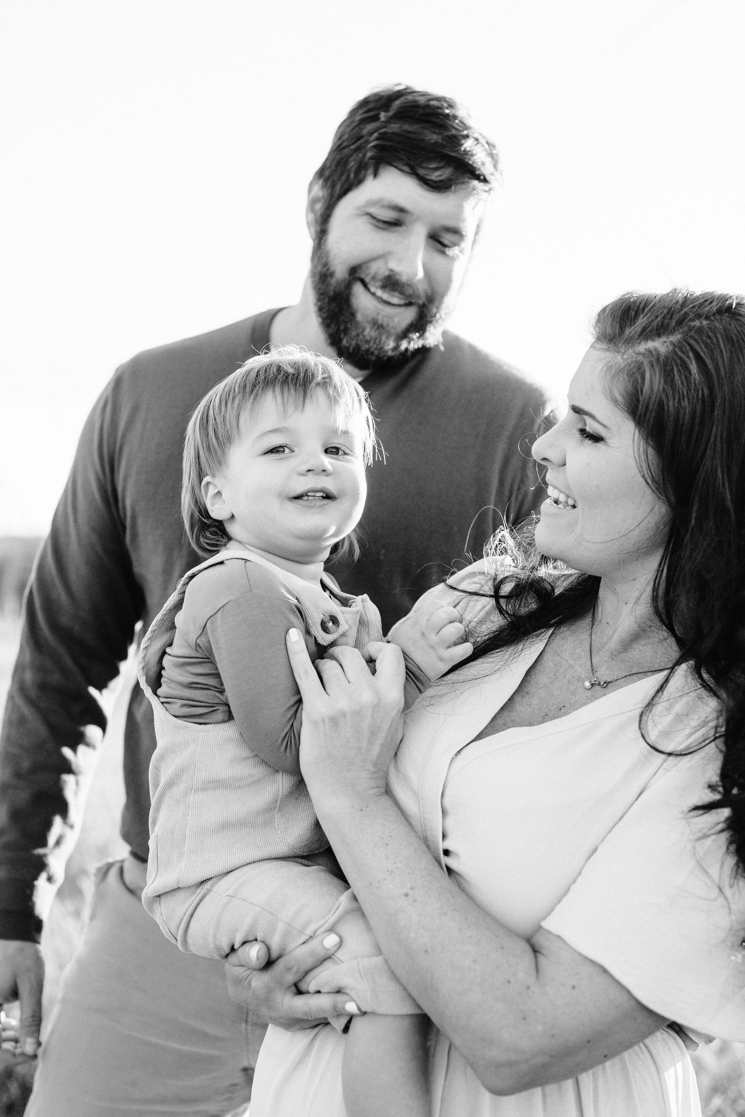 Black and white intimate family portrait showing joyful expressions.