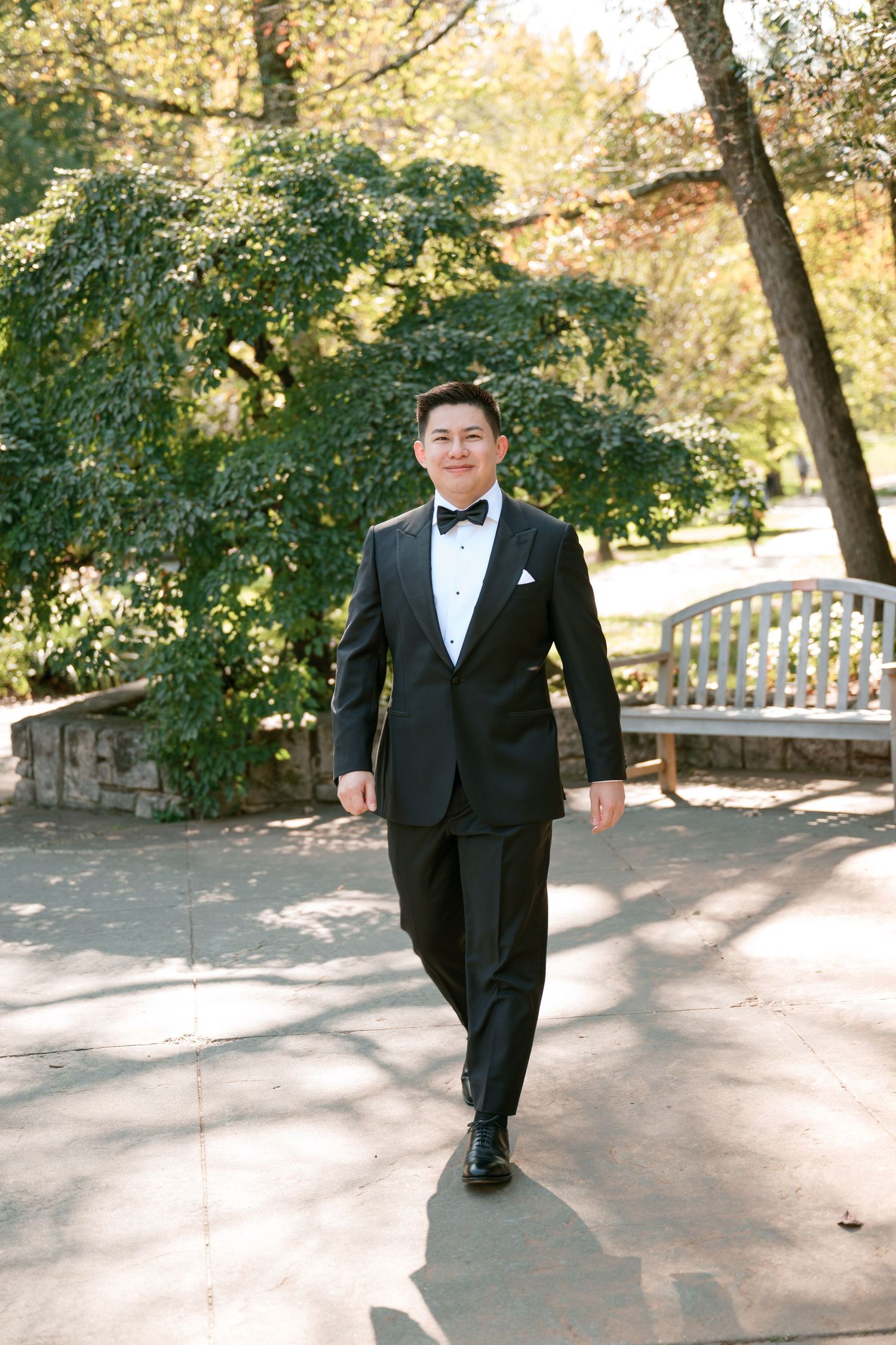Formal wedding attire being showcased in an outdoor garden setting.