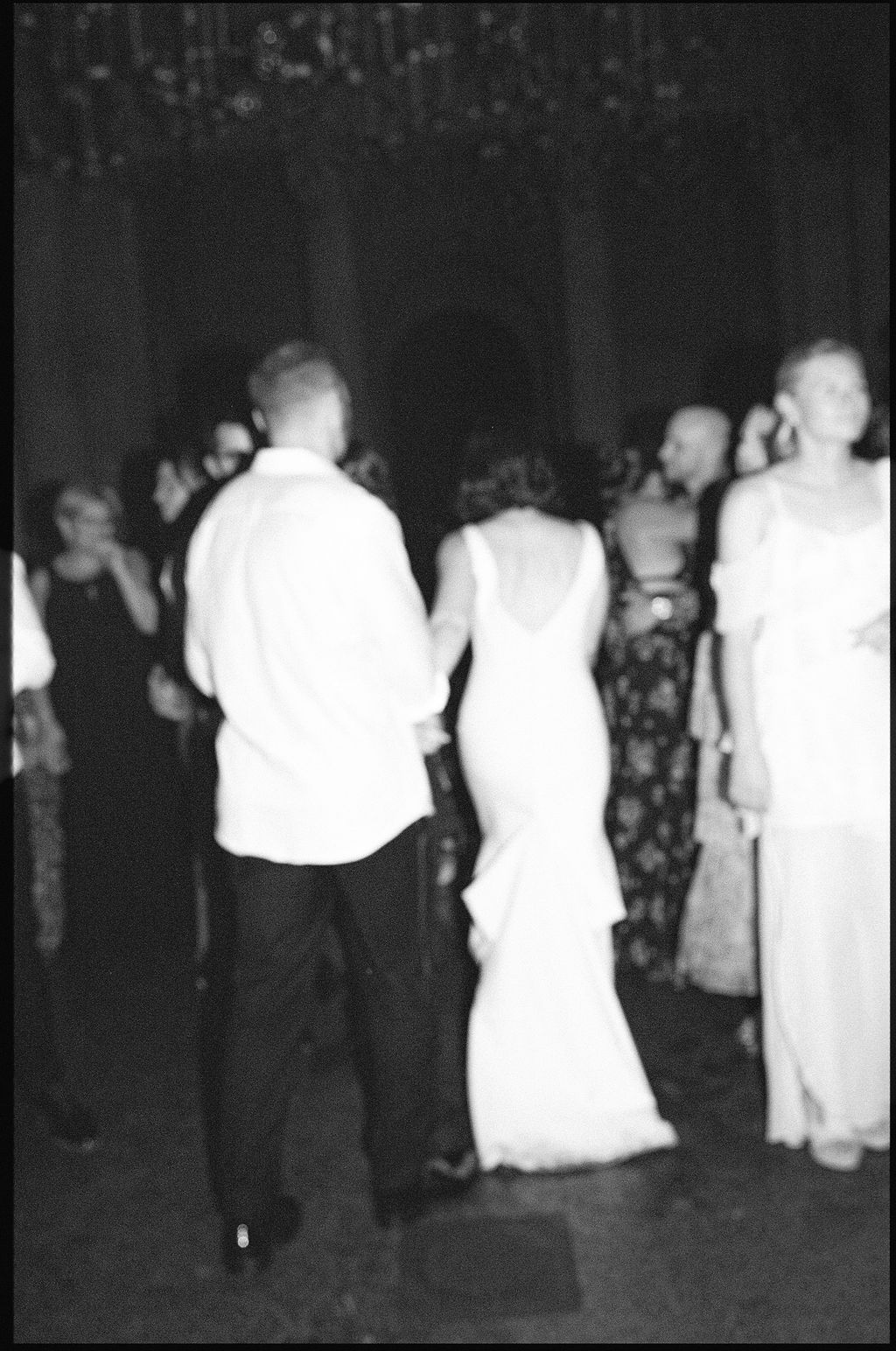 A series of vintage black and white photos showing people dancing at a formal event in dark evening attire.