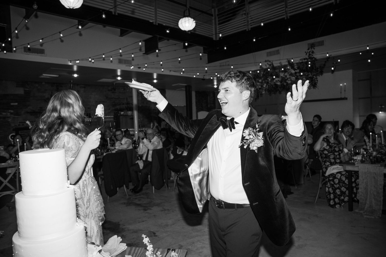 Wedding reception dance floor filled with celebrating guests under starlit ceiling.