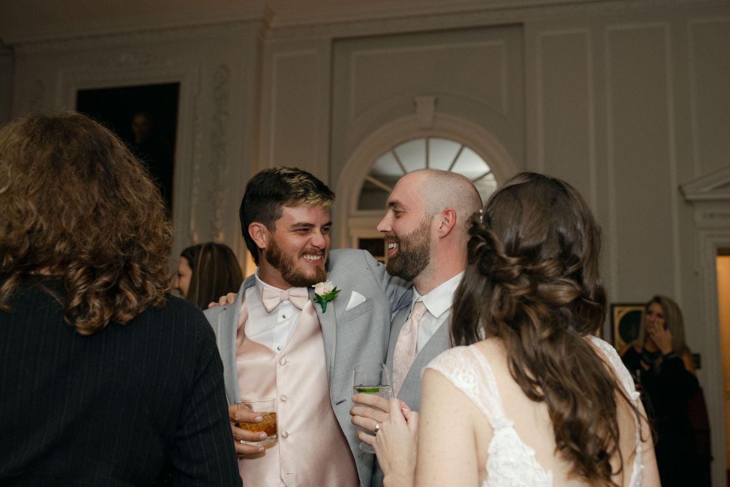 Wedding guests enjoying conversation and drinks during the evening reception.