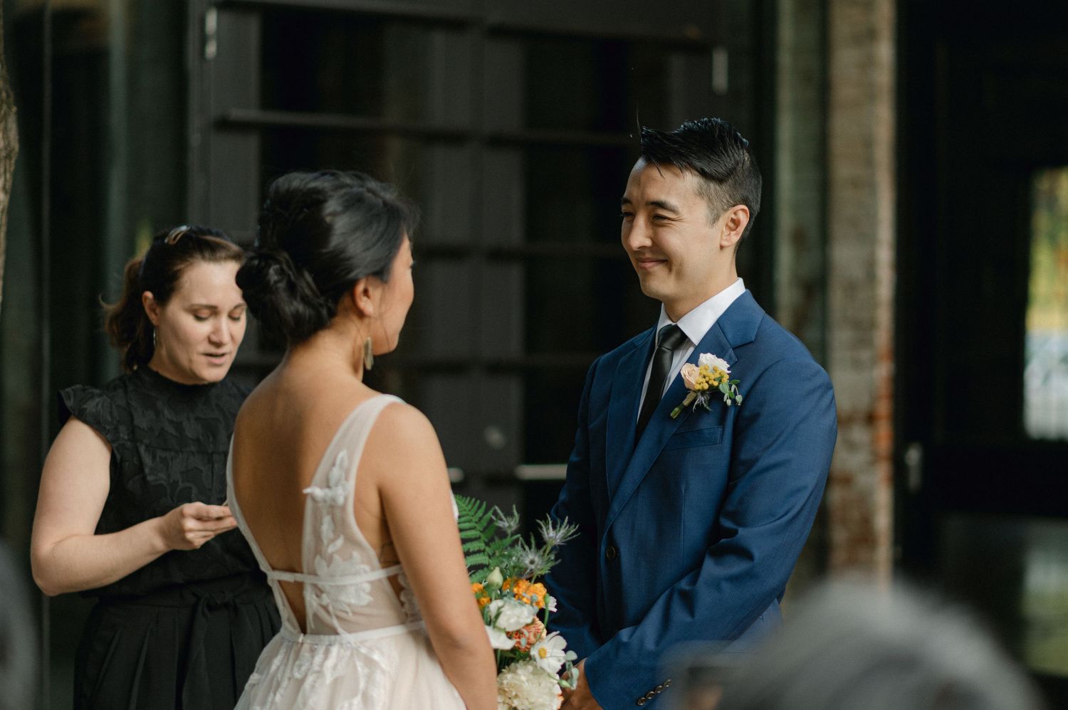 groom smiles during wedding ceremony
