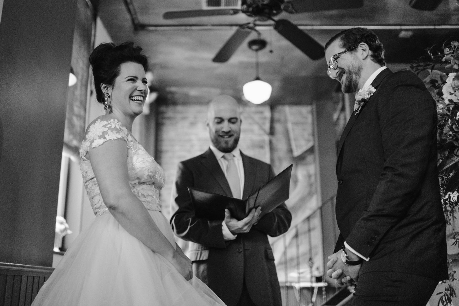 A black and white capture of a wedding ceremony with laughter and joy.