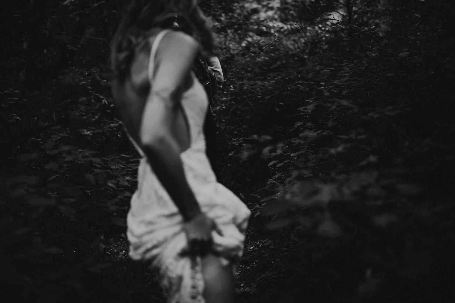 Artistic black and white photo of a flowing white dress in motion.